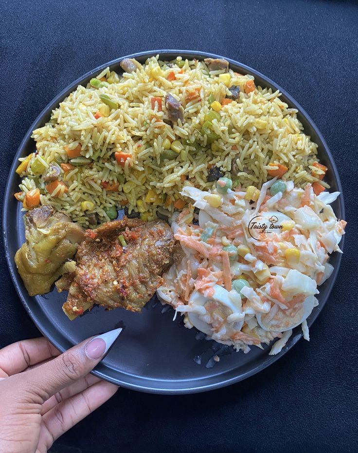 Nigerian fried rice served with seasoned chicken